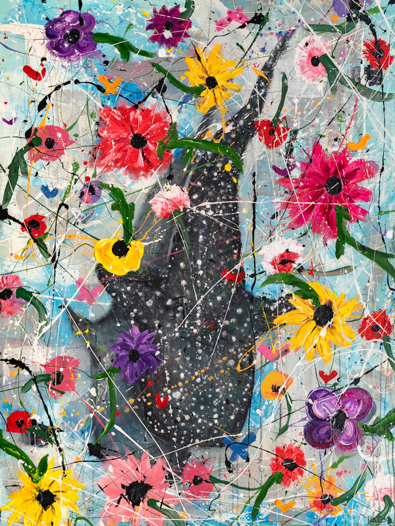 A colorful abstract floral artwork featuring a large dark gray whale silhouette layered over splattered paint, with pink, red, yellow, purple, and blue flowers and green leaves throughout.